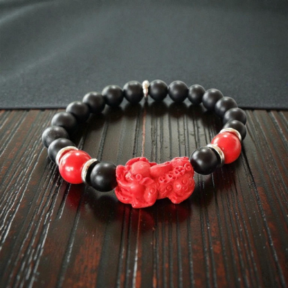 Pixiu Bracelet for men featuring red cinnabar and black onyx beads, designed as a powerful Feng Shui jewelry piece to attract abundance, wealth, and good luck. Inspired by the dragon zodiac, this handmade bracelet symbolizes protection and prosperity. Perfect as a meaningful gift for him, it combines spiritual energy with stylish craftsmanship. Ideal for daily wear or special occasions, enhancing confidence and positive vibes.