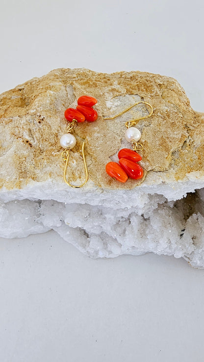 Handmade orange coral and pearl drop earrings featuring intricate beaded dangle design, perfect for women who love boho style jewelry. These statement earrings combine vibrant coral beads with elegant pearls, creating a unique accessory ideal for gifting or adding a pop of color to any outfit. Lightweight and comfortable, these coral jewelry earrings are perfect for casual or special occasions, making a bold fashion statement.