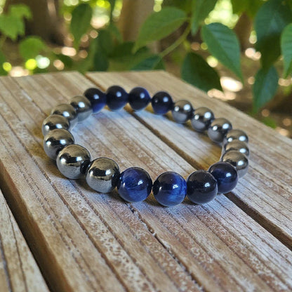 Blue Tiger Eye Hematite Bracelet handcrafted with natural stones including lapis lazuli, polished hematite, and deep blue tiger eye. This unisex stretch bracelet blends style and energy, offering grounding, focus, and protection. A perfect lucky charm and thoughtful gift for men or women, ideal for daily wear or spiritual practice. Handmade with care, this natural stone bracelet is a unique accessory for those who value wellness and intentional living.