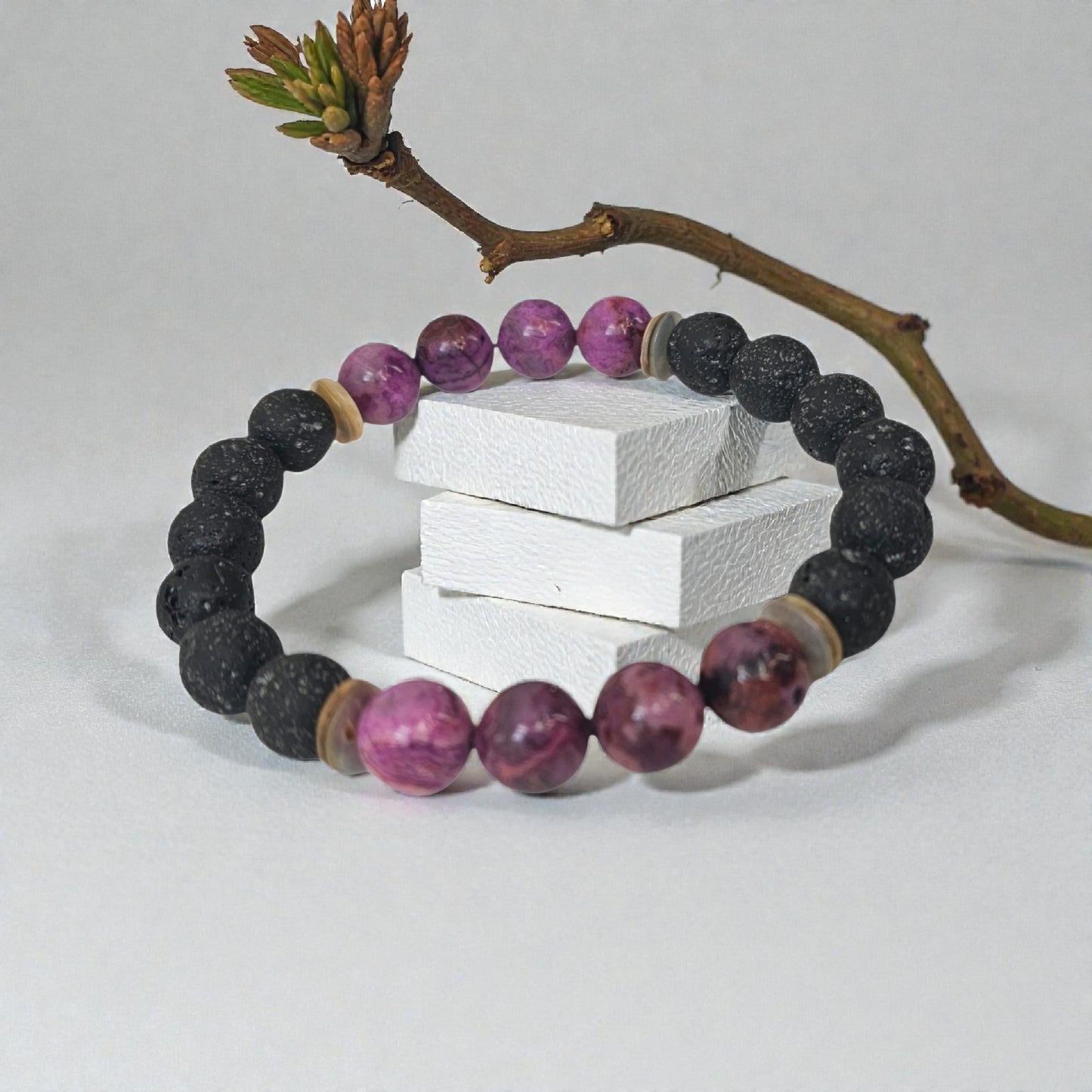 Handmade aromatherapy diffuser bracelet featuring natural purple agate and black lava stones, designed for men and women seeking healing crystal jewelry. This stylish bracelet combines the calming properties of agate with porous lava beads perfect for essential oils, offering both wellness benefits and a fashionable accessory. Ideal as an anniversary gift, this unisex bracelet blends holistic healing with modern handcrafted design.