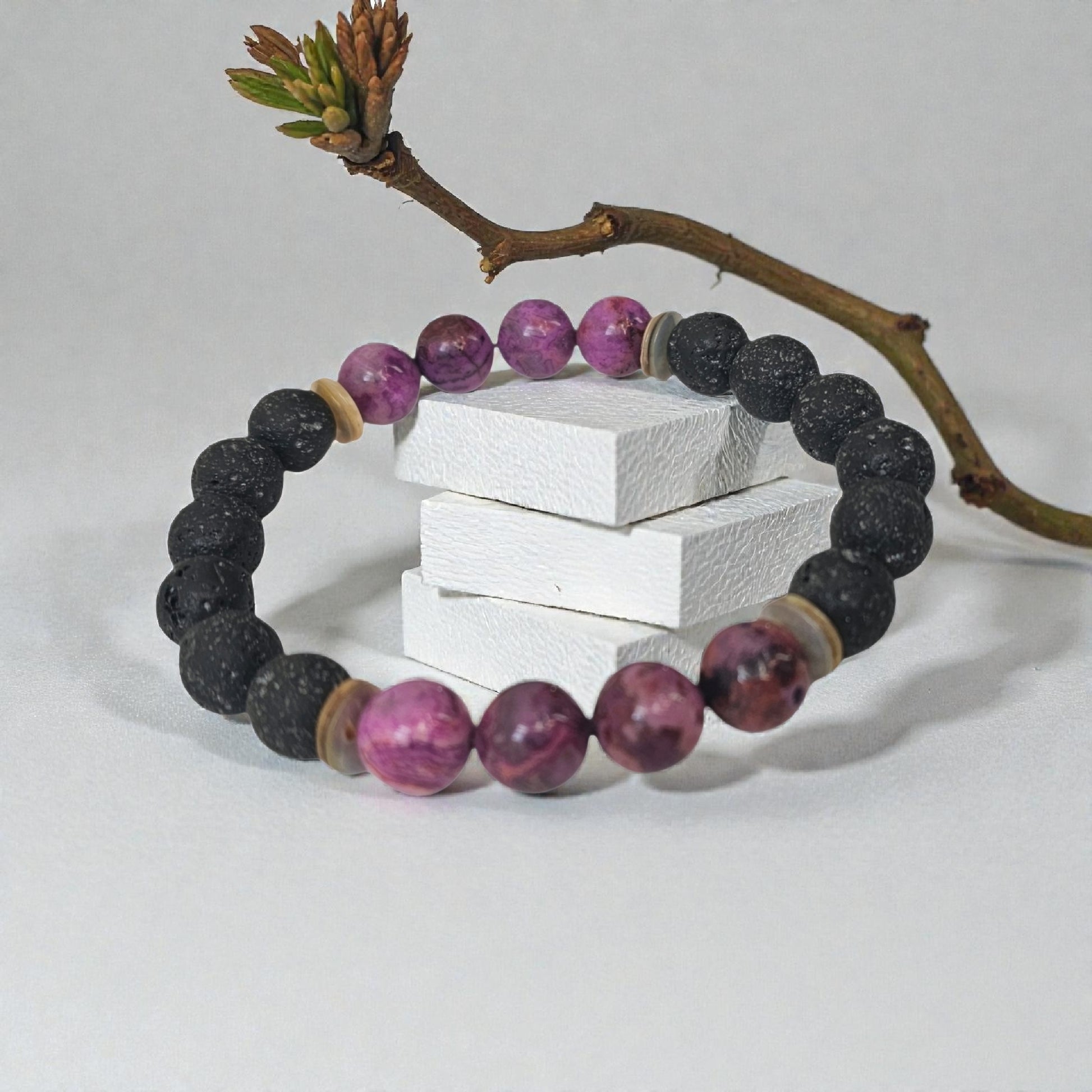 Handmade aromatherapy diffuser bracelet featuring natural purple agate and black lava stones, designed for men and women seeking healing crystal jewelry. This stylish bracelet combines the calming properties of agate with porous lava beads perfect for essential oils, offering both wellness benefits and a fashionable accessory. Ideal as an anniversary gift, this unisex bracelet blends holistic healing with modern handcrafted design.