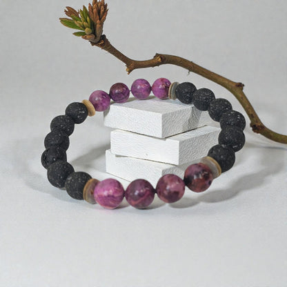 Handmade aromatherapy diffuser bracelet featuring natural purple agate and black lava stones, designed for men and women seeking healing crystal jewelry. This stylish bracelet combines the calming properties of agate with porous lava beads perfect for essential oils, offering both wellness benefits and a fashionable accessory. Ideal as an anniversary gift, this unisex bracelet blends holistic healing with modern handcrafted design.