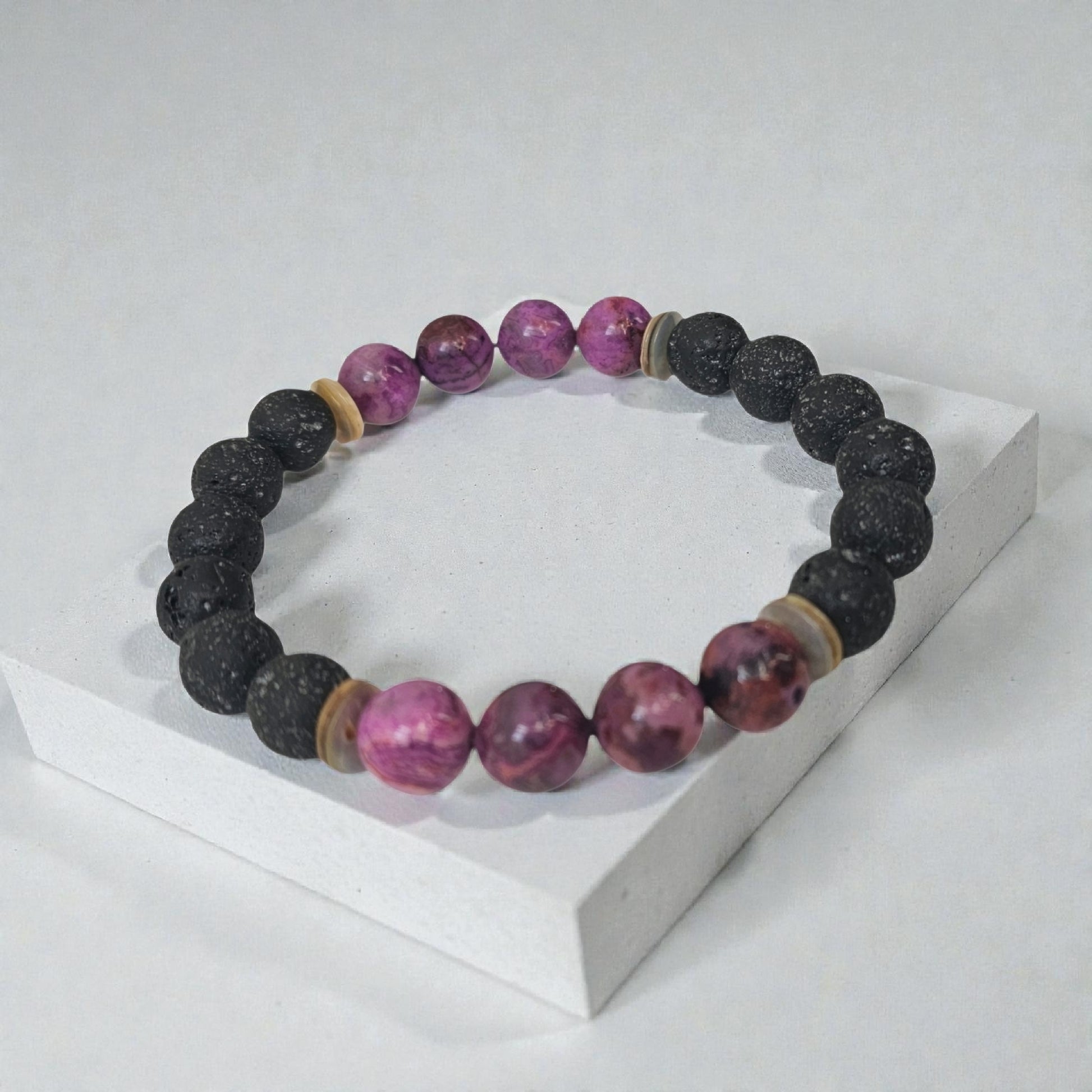 Handmade aromatherapy diffuser bracelet featuring natural purple agate and black lava stones, designed for men and women seeking healing crystal jewelry. This stylish bracelet combines the calming properties of agate with porous lava beads perfect for essential oils, offering both wellness benefits and a fashionable accessory. Ideal as an anniversary gift, this unisex bracelet blends holistic healing with modern handcrafted design.
