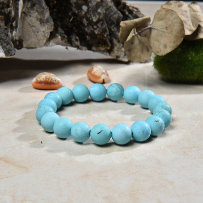 Magnesite Turquoise Stretch Bracelet designed for women and men, featuring blue stone beads known for their healing and chakra-balancing properties. This handcrafted boho crystal jewelry offers both style and spiritual energy, perfect for those seeking natural wellness accessories. Lightweight and comfortable, it makes a thoughtful gift that promotes calmness, positivity, and balance. Ideal for everyday wear, meditation, or adding a vibrant, earthy touch to any outfit.