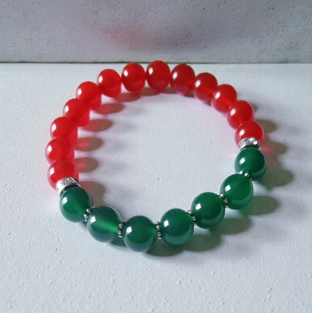 Green and Red Onyx Crystal Bracelet featuring handmade beaded design crafted for both women and men. This lucky charm jewelry combines vibrant green and deep red onyx stones, known for promoting abundance, protection, and positive energy. Perfect as a meaningful gift for him or her, this stylish bracelet blends artisanal craftsmanship with spiritual benefits. Lightweight and versatile, it adds a powerful and elegant touch to everyday wear or special occasions.