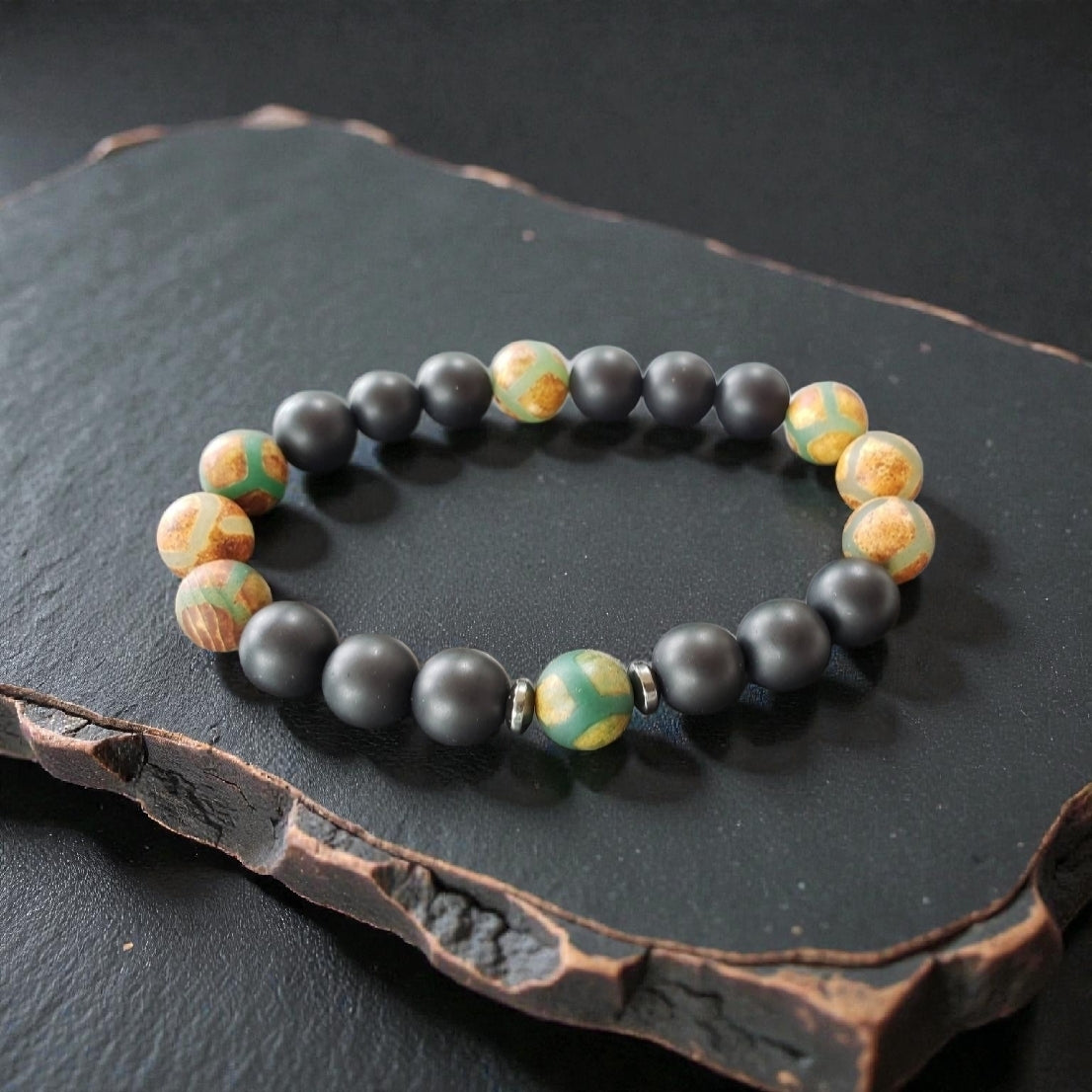 Handmade Tibetan-style black onyx and agate bracelet featuring healing gemstones known for their protective and grounding properties. This men’s lucky charm jewelry piece blends traditional craftsmanship with modern style, making it an ideal gift for him. Perfect for everyday wear or special occasions, the bracelet offers both spiritual benefits and a bold, masculine accessory that complements any outfit with its sleek black design.