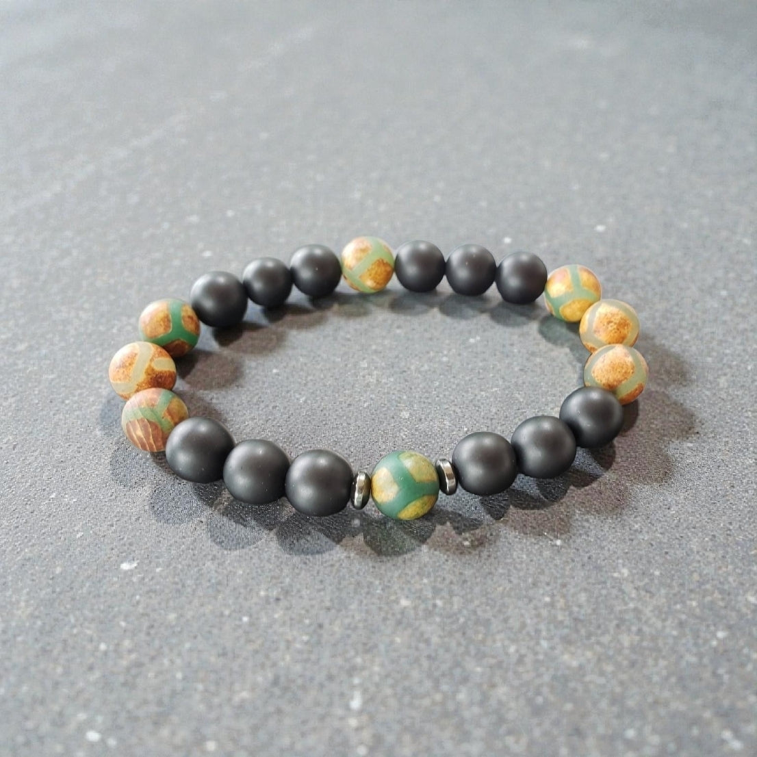 Handmade Tibetan-style black onyx and agate bracelet featuring healing gemstones known for their protective and grounding properties. This men’s lucky charm jewelry piece blends traditional craftsmanship with modern style, making it an ideal gift for him. Perfect for everyday wear or special occasions, the bracelet offers both spiritual benefits and a bold, masculine accessory that complements any outfit with its sleek black design.