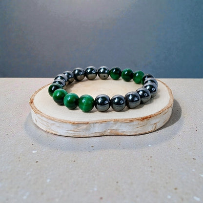 Handmade unisex bracelet featuring natural tiger eye and hematite stones, designed as a stylish lucky charm accessory for men and women. This green-hued natural stone bracelet combines grounding and protective properties, perfect for everyday wear or gifting. Crafted with care, it offers a unique blend of earthy elegance and modern style, making it a versatile jewelry piece suitable for anyone seeking both fashion and positive energy.