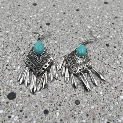Handmade turquoise tassel earrings featuring natural stone beads and diamond alloy accents, perfect for women who love boho jewelry. These lightweight statement earrings combine vibrant turquoise hues with elegant tassel details for a unique and stylish look. Ideal for casual or dressy occasions, they add a pop of color and texture to any outfit. A beautiful accessory that blends natural elements with chic design, making it a perfect gift or everyday favorite.