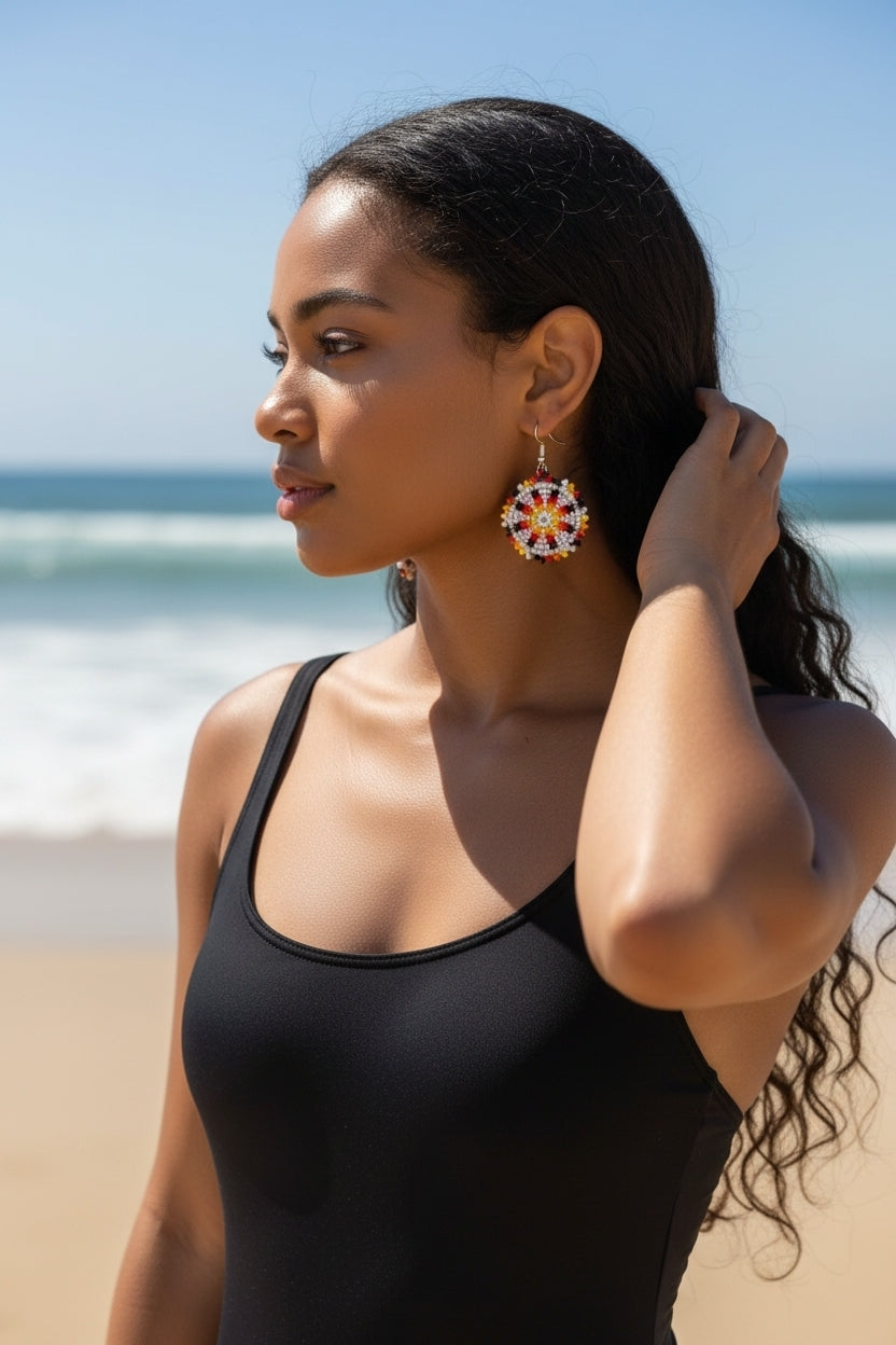Handmade white and yellow beaded earrings in native ethnic style, featuring intricate tribal medallion design. These artisan statement earrings are perfect for women who appreciate unique, handcrafted jewelry inspired by traditional tribal patterns. Lightweight and bold, they make an excellent gift and add a touch of cultural elegance to any outfit, ideal for everyday wear or special occasions with a vibrant ethnic flair.