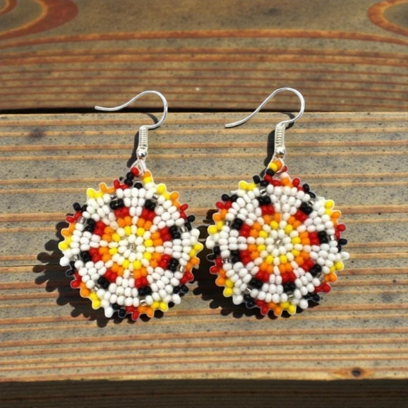 Handmade white and yellow beaded earrings in native ethnic style, featuring intricate tribal medallion design. These artisan statement earrings are perfect for women who appreciate unique, handcrafted jewelry inspired by traditional tribal patterns. Lightweight and bold, they make an excellent gift and add a touch of cultural elegance to any outfit, ideal for everyday wear or special occasions with a vibrant ethnic flair.