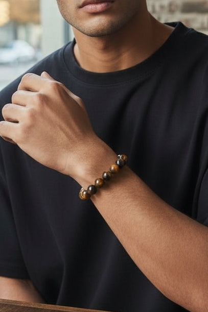 Tiger Eye Bracelet for men featuring natural healing crystals known for protection, strength, and balance. This stylish spiritual jewelry is designed to promote positive energy and calm, making it a meaningful gift for him—perfect for husbands or boyfriends. Handmade with quality beads, it combines durability and fashion for everyday wear. Ideal for meditation, casual outfits, or special occasions, blending wellness with masculine style.