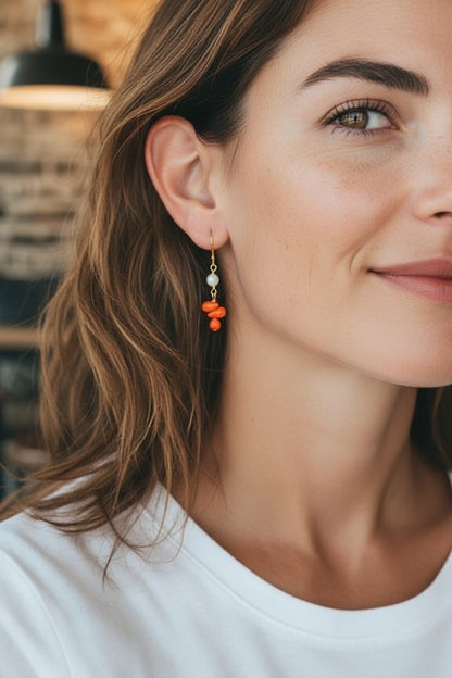 Handmade orange coral and pearl drop earrings featuring intricate beaded dangle design, perfect for women who love boho style jewelry. These statement earrings combine vibrant coral beads with elegant pearls, creating a unique accessory ideal for gifting or adding a pop of color to any outfit. Lightweight and comfortable, these coral jewelry earrings are perfect for casual or special occasions, making a bold fashion statement.