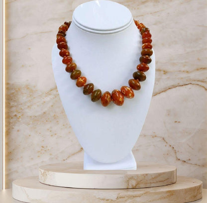 Handmade chunky agate necklace for women featuring vibrant carnelian, amber, and vintage-style lucite beads in bold orange tones. This unique statement necklace blends natural gemstones with retro-inspired design, creating a one-of-a-kind accessory perfect for those who love standout jewelry. Ideal as a gift for her, it adds a warm, artistic touch to any outfit and showcases a mix of earthy elegance and vintage charm.