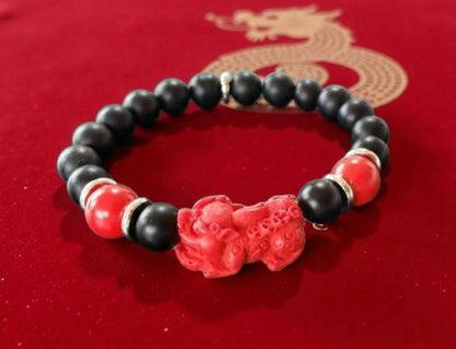 Pixiu Bracelet for men featuring red cinnabar and black onyx beads, designed as a powerful Feng Shui jewelry piece to attract abundance, wealth, and good luck. Inspired by the dragon zodiac, this handmade bracelet symbolizes protection and prosperity. Perfect as a meaningful gift for him, it combines spiritual energy with stylish craftsmanship. Ideal for daily wear or special occasions, enhancing confidence and positive vibes.