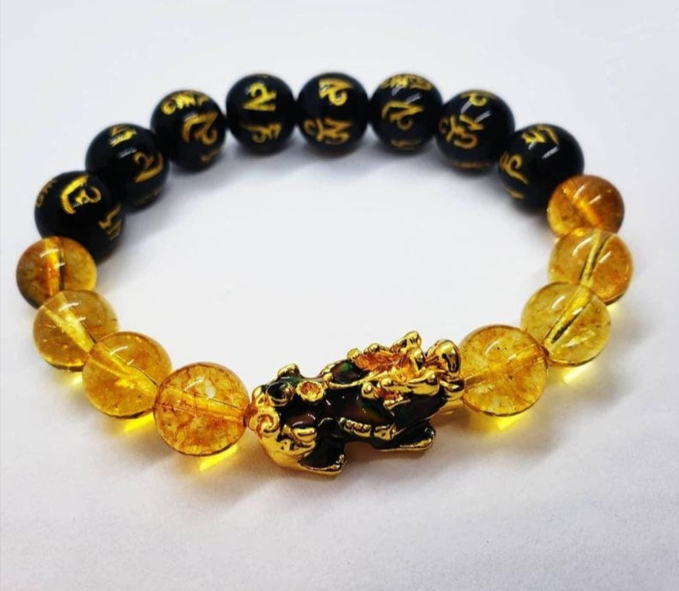 Citrine Obsidian Pixiu bracelet designed for wealth attraction and protection, handcrafted with natural crystals. This Feng Shui-inspired healing jewelry piece combines the powerful energy of citrine and obsidian stones, believed to enhance prosperity, ward off negative energy, and bring balance. Suitable for men and women, it makes a meaningful gift for those seeking spiritual harmony and positive energy in daily life.