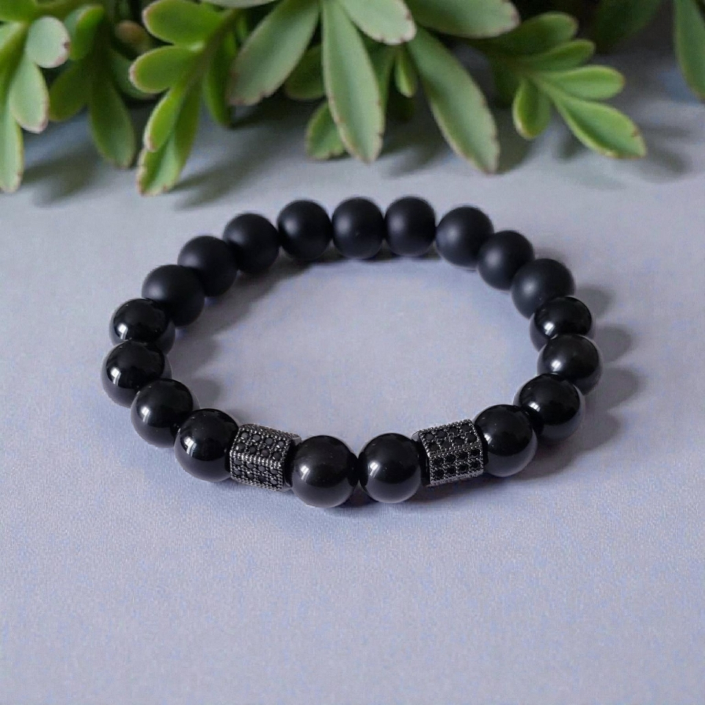 Black Obsidian Onyx Protection Bracelet handmade with natural crystal stones, including Hematite and Lava rock beads. This healing energy bracelet offers grounding and protective properties, perfect for men seeking balance, focus, and emotional strength. Ideal for yoga, meditation, or daily wear, the stylish charm design blends spiritual wellness with fashion. Unique crystal jewelry for men, handcrafted for holistic energy and intention.