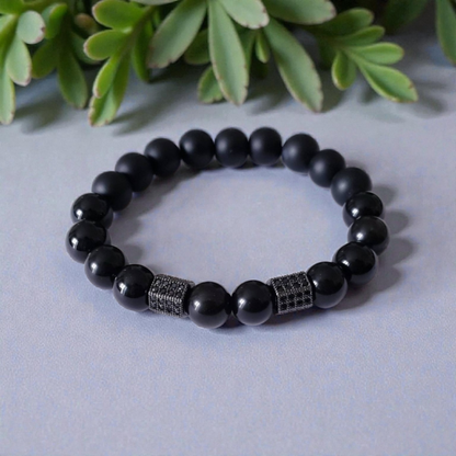 Black Obsidian Onyx Protection Bracelet handmade with natural crystal stones, including Hematite and Lava rock beads. This healing energy bracelet offers grounding and protective properties, perfect for men seeking balance, focus, and emotional strength. Ideal for yoga, meditation, or daily wear, the stylish charm design blends spiritual wellness with fashion. Unique crystal jewelry for men, handcrafted for holistic energy and intention.