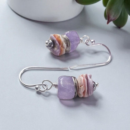 Purple Morganite Minimalist Earrings crafted in sterling silver with 8mm gemstone accents and delicate pectin scallop shell design. These handmade ocean-inspired earrings offer a soft, elegant touch for women who love beach-themed or nautical jewelry. Perfect as a thoughtful gift, bridesmaid accessory, or everyday wear. Lightweight and stylish, they blend natural beauty with minimalist charm, making them ideal for coastal weddings, summer fashion, or ocean lovers.