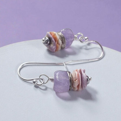 Purple Morganite Minimalist Earrings crafted in sterling silver with 8mm gemstone accents and delicate pectin scallop shell design. These handmade ocean-inspired earrings offer a soft, elegant touch for women who love beach-themed or nautical jewelry. Perfect as a thoughtful gift, bridesmaid accessory, or everyday wear. Lightweight and stylish, they blend natural beauty with minimalist charm, making them ideal for coastal weddings, summer fashion, or ocean lovers.