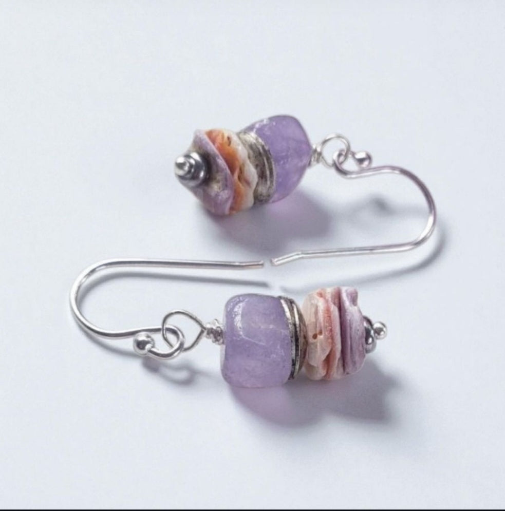 Purple Morganite Minimalist Earrings crafted in sterling silver with 8mm gemstone accents and delicate pectin scallop shell design. These handmade ocean-inspired earrings offer a soft, elegant touch for women who love beach-themed or nautical jewelry. Perfect as a thoughtful gift, bridesmaid accessory, or everyday wear. Lightweight and stylish, they blend natural beauty with minimalist charm, making them ideal for coastal weddings, summer fashion, or ocean lovers.