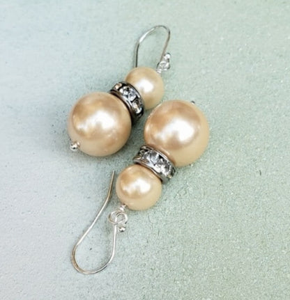 Natural Shell Pearl Dangle Earrings featuring ivory pearls sized 6-10mm set in sterling silver, handcrafted for women. These elegant bridesmaid earrings combine classic pearl beauty with delicate shell accents, creating a timeless accessory perfect for weddings, special occasions, or everyday wear. Lightweight and refined, they make a thoughtful gift for her, blending artisanal craftsmanship with sophisticated style for unforgettable jewelry moments.