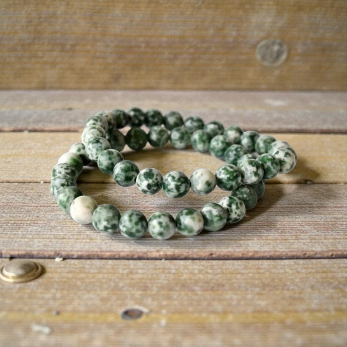 Green Spot Jasper Healing Bracelet featuring natural stone beads crafted to promote energy balance, meditation, and chakra healing for women. This handcrafted crystal jewelry combines the soothing green hues of spot jasper with artisanal beadwork, offering both spiritual benefits and stylish wearability. Ideal for those seeking calming energy and wellness, this bracelet serves as a meaningful accessory for everyday use or mindful practices, blending beauty with holistic healing properties.