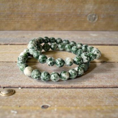 Green Spot Jasper Healing Bracelet featuring natural stone beads crafted to promote energy balance, meditation, and chakra healing for women. This handcrafted crystal jewelry combines the soothing green hues of spot jasper with artisanal beadwork, offering both spiritual benefits and stylish wearability. Ideal for those seeking calming energy and wellness, this bracelet serves as a meaningful accessory for everyday use or mindful practices, blending beauty with holistic healing properties.
