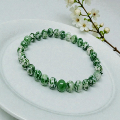 Green Spot Jasper Healing Bracelet featuring natural stone beads crafted to promote energy balance, meditation, and chakra healing for women. This handcrafted crystal jewelry combines the soothing green hues of spot jasper with artisanal beadwork, offering both spiritual benefits and stylish wearability. Ideal for those seeking calming energy and wellness, this bracelet serves as a meaningful accessory for everyday use or mindful practices, blending beauty with holistic healing properties.