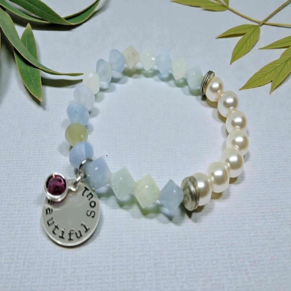 Aquamarine Pearl Bracelet featuring handmade beaded design combining soothing aquamarine stones with lustrous pearls. This inspirational jewelry piece is perfect as a March birthstone gift, symbolizing calmness, courage, and good luck. Ideal for her or as a thoughtful mother’s gift, it blends elegant style with meaningful healing properties. Lightweight and versatile, this bracelet adds a delicate, spiritual touch to everyday wear or special occasions, celebrating love and positive energy.