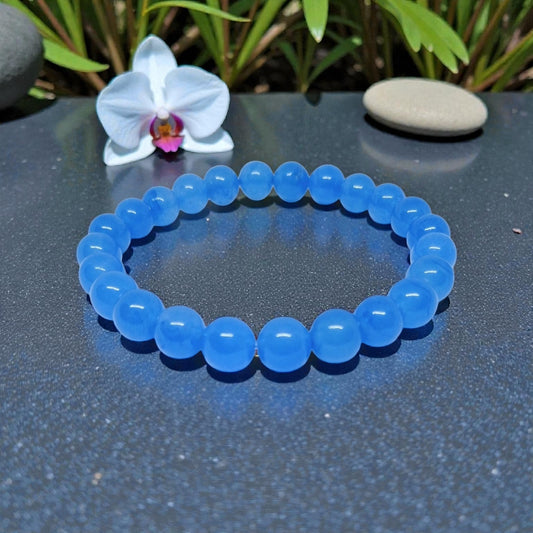 Chalcedony Bracelet featuring healing blue beads crafted from natural crystal stones, designed as a stretch friendship bracelet for women and men. This handmade round beaded jewelry piece promotes calmness, emotional balance, and positive energy. Lightweight and comfortable, it makes a meaningful gift symbolizing connection and wellness. Perfect for everyday wear or spiritual practices, combining artisanal craftsmanship with the soothing beauty of chalcedony gemstones.