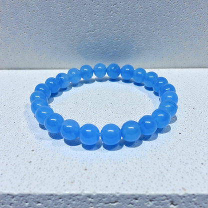 Chalcedony Bracelet featuring healing blue beads crafted from natural crystal stones, designed as a stretch friendship bracelet for women and men. This handmade round beaded jewelry piece promotes calmness, emotional balance, and positive energy. Lightweight and comfortable, it makes a meaningful gift symbolizing connection and wellness. Perfect for everyday wear or spiritual practices, combining artisanal craftsmanship with the soothing beauty of chalcedony gemstones.