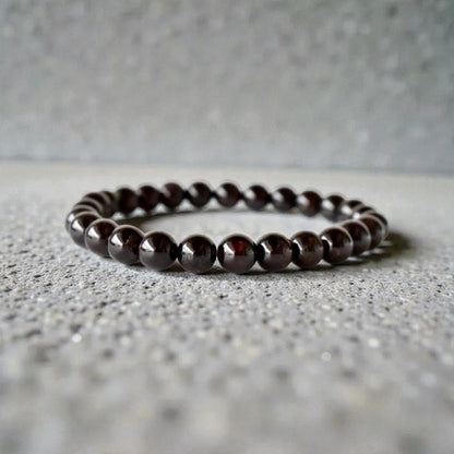 Garnet Handmade Bracelet featuring natural deep red crystal beads crafted into a healing energy design for women and men. This unisex gemstone bracelet promotes strength, passion, and energy balance, making it a meaningful gift for her or him. Perfect for daily wear, meditation, or spiritual wellness, it blends natural beauty with artisan craftsmanship. Lightweight and powerful, this bracelet adds a bold touch to any outfit while supporting emotional and physical grounding.