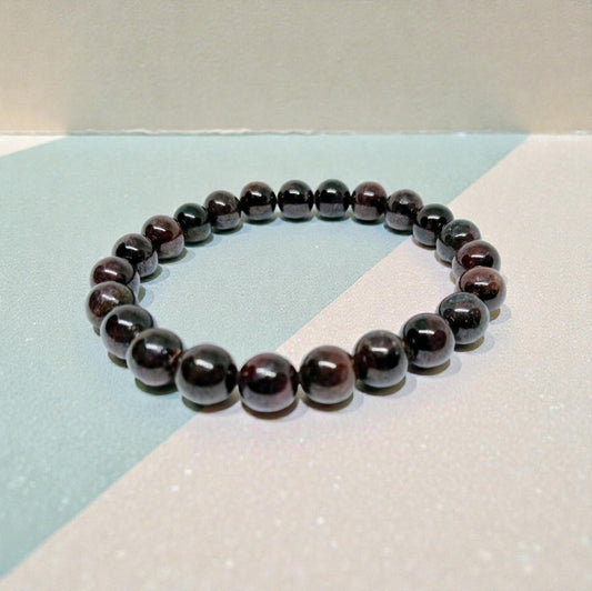 Garnet Handmade Bracelet featuring natural deep red crystal beads crafted into a healing energy design for women and men. This unisex gemstone bracelet promotes strength, passion, and energy balance, making it a meaningful gift for her or him. Perfect for daily wear, meditation, or spiritual wellness, it blends natural beauty with artisan craftsmanship. Lightweight and powerful, this bracelet adds a bold touch to any outfit while supporting emotional and physical grounding.