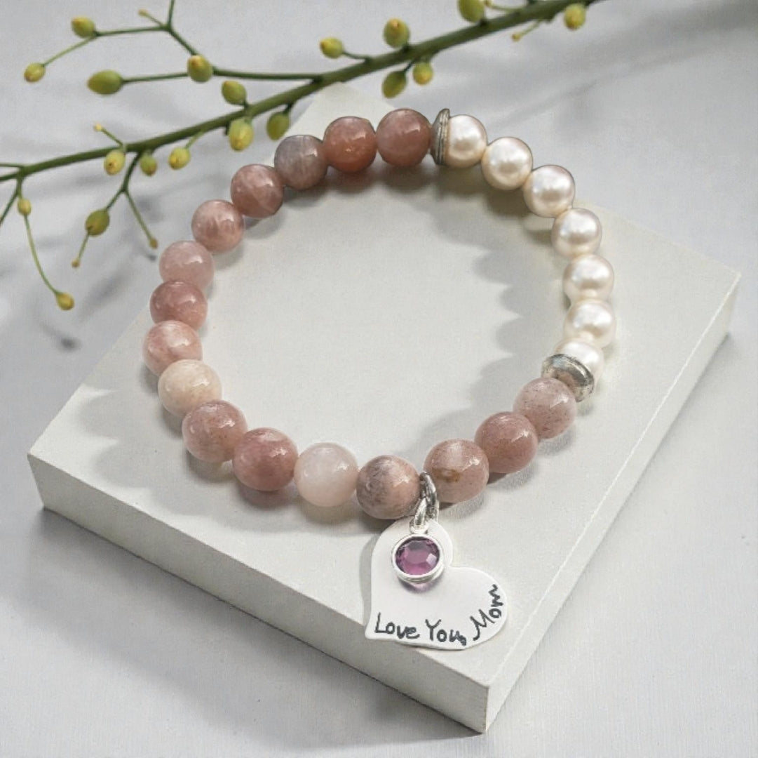 Sunstone pearl bracelet handcrafted with warm sunstone gemstones, luminous freshwater pearls, and a sterling silver charm for a boho-inspired, radiant look. This meaningful jewelry piece symbolizes joy, confidence, and positive energy, making it ideal for everyday wear or special occasions. A thoughtful gift for women who love natural stone jewelry, beachy style, or spiritual accessories, perfect for birthdays, anniversaries, holidays, or self-care gifting.