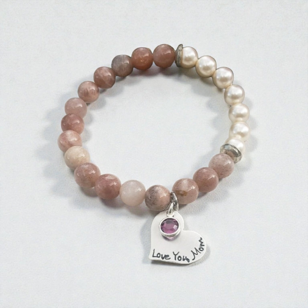 Sunstone pearl bracelet handcrafted with warm sunstone gemstones, luminous freshwater pearls, and a sterling silver charm for a boho-inspired, radiant look. This meaningful jewelry piece symbolizes joy, confidence, and positive energy, making it ideal for everyday wear or special occasions. A thoughtful gift for women who love natural stone jewelry, beachy style, or spiritual accessories, perfect for birthdays, anniversaries, holidays, or self-care gifting.