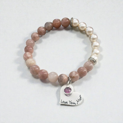 Sunstone pearl bracelet handcrafted with warm sunstone gemstones, luminous freshwater pearls, and a sterling silver charm for a boho-inspired, radiant look. This meaningful jewelry piece symbolizes joy, confidence, and positive energy, making it ideal for everyday wear or special occasions. A thoughtful gift for women who love natural stone jewelry, beachy style, or spiritual accessories, perfect for birthdays, anniversaries, holidays, or self-care gifting.