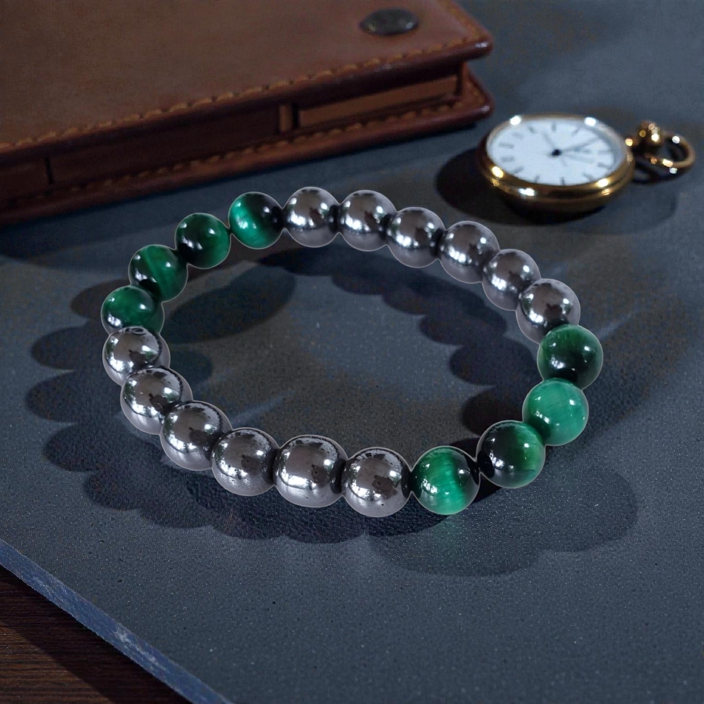 Handmade unisex bracelet featuring natural tiger eye and hematite stones, designed as a stylish lucky charm accessory for men and women. This green-hued natural stone bracelet combines grounding and protective properties, perfect for everyday wear or gifting. Crafted with care, it offers a unique blend of earthy elegance and modern style, making it a versatile jewelry piece suitable for anyone seeking both fashion and positive energy.