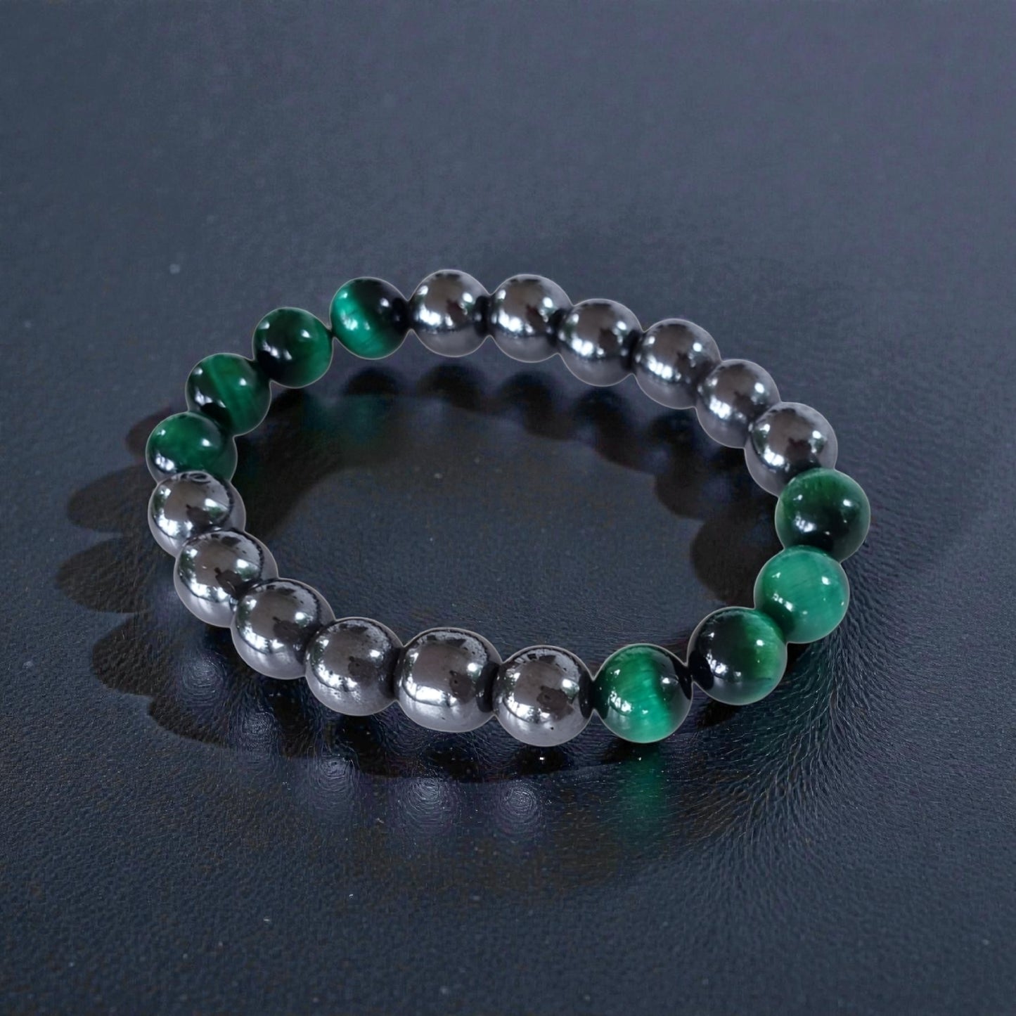 Handmade unisex bracelet featuring natural tiger eye and hematite stones, designed as a stylish lucky charm accessory for men and women. This green-hued natural stone bracelet combines grounding and protective properties, perfect for everyday wear or gifting. Crafted with care, it offers a unique blend of earthy elegance and modern style, making it a versatile jewelry piece suitable for anyone seeking both fashion and positive energy.