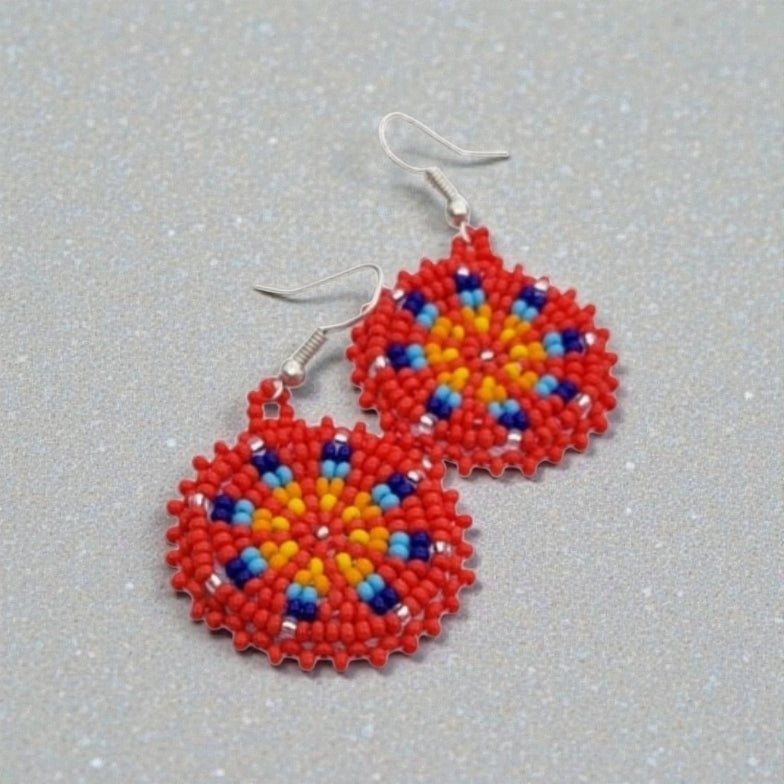 Red Handmade Beaded Earrings for women featuring vibrant native-style beadwork with multicolor accents in a bold boho medallion design. These statement festival earrings showcase intricate craftsmanship and colorful patterns, perfect for adding a pop of color to any outfit. Ideal gift for women who appreciate unique, artisanal jewelry with cultural significance. Lightweight and striking, these earrings elevate both casual and festive looks with artistic flair.