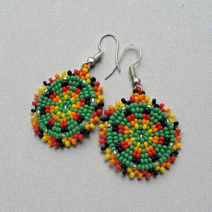 Green Handmade Beaded Earrings for women featuring intricate native-style beadwork in a bold boho design. These statement green medallion earrings showcase vibrant beads arranged in festival-inspired patterns, perfect for adding color and artistry to any outfit. Ideal gift for women who love unique, handcrafted jewelry with cultural flair. Lightweight and eye-catching, these earrings complement casual and dressy looks alike, making them perfect for festivals or everyday wear.