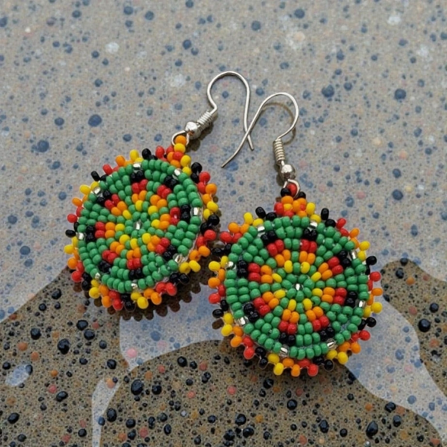 Green Handmade Beaded Earrings for women featuring intricate native-style beadwork in a bold boho design. These statement green medallion earrings showcase vibrant beads arranged in festival-inspired patterns, perfect for adding color and artistry to any outfit. Ideal gift for women who love unique, handcrafted jewelry with cultural flair. Lightweight and eye-catching, these earrings complement casual and dressy looks alike, making them perfect for festivals or everyday wear.