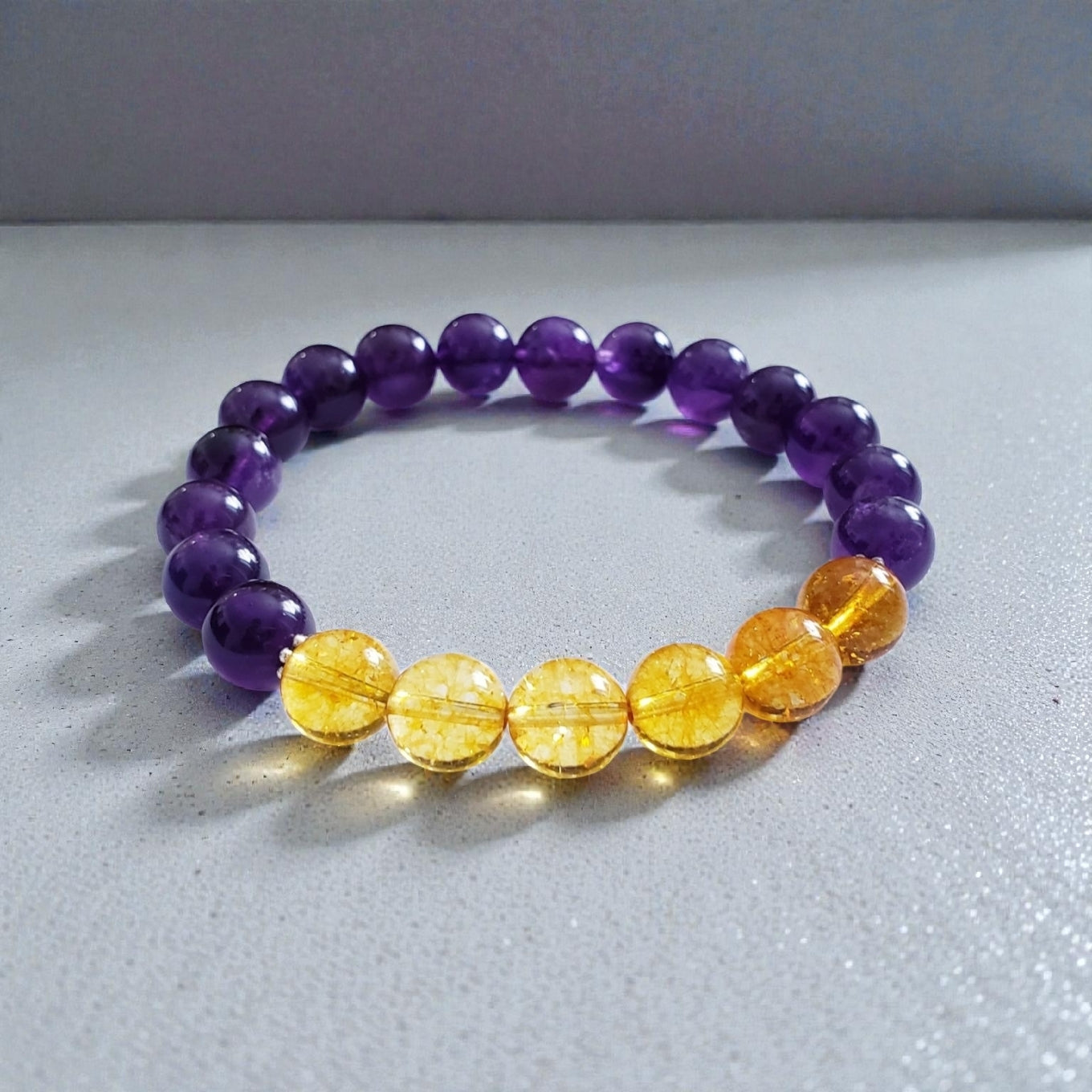 Amethyst and Citrine Crystal Bracelet for women, handcrafted with natural gemstones known for healing and positive energy. This inspirational bracelet combines the calming purple hues of amethyst with the vibrant yellow of citrine, promoting balance, clarity, and optimism. Handmade with care, it’s an ideal gift for anyone seeking spiritual wellness and stylish crystal jewelry. Perfect for everyday wear or special occasions to uplift mood and energy.