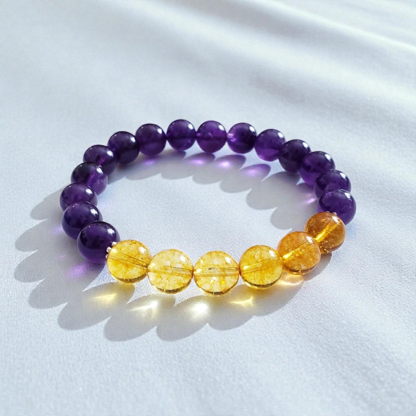 Amethyst and Citrine Crystal Bracelet for women, handcrafted with natural gemstones known for healing and positive energy. This inspirational bracelet combines the calming purple hues of amethyst with the vibrant yellow of citrine, promoting balance, clarity, and optimism. Handmade with care, it’s an ideal gift for anyone seeking spiritual wellness and stylish crystal jewelry. Perfect for everyday wear or special occasions to uplift mood and energy.