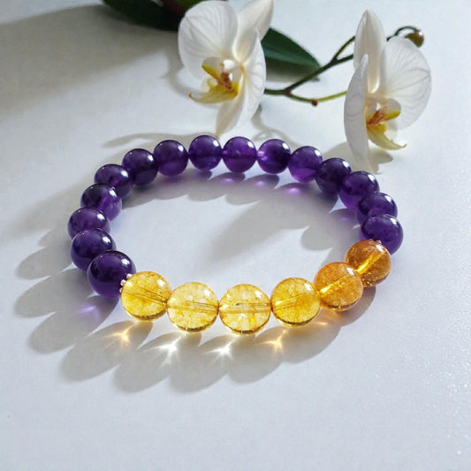 Amethyst and Citrine Crystal Bracelet for women, handcrafted with natural gemstones known for healing and positive energy. This inspirational bracelet combines the calming purple hues of amethyst with the vibrant yellow of citrine, promoting balance, clarity, and optimism. Handmade with care, it’s an ideal gift for anyone seeking spiritual wellness and stylish crystal jewelry. Perfect for everyday wear or special occasions to uplift mood and energy.