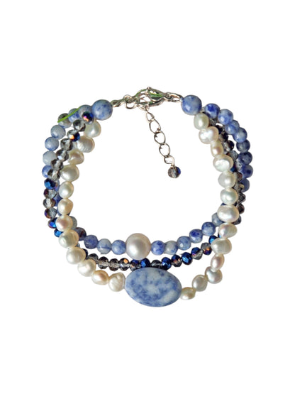 Handmade multi-strand bracelet featuring sodalite and cultured pearl beads, designed as chunky crystal jewelry with a minimalist pendant accent. This beaded bracelet offers a stylish and elegant accessory perfect for girls who love unique, handcrafted pieces. Combining natural gemstones with delicate craftsmanship, it makes a thoughtful gift ideal for special occasions or everyday wear, blending boho charm with modern minimalist style.