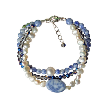 Handmade multi-strand bracelet featuring sodalite and cultured pearl beads, designed as chunky crystal jewelry with a minimalist pendant accent. This beaded bracelet offers a stylish and elegant accessory perfect for girls who love unique, handcrafted pieces. Combining natural gemstones with delicate craftsmanship, it makes a thoughtful gift ideal for special occasions or everyday wear, blending boho charm with modern minimalist style.