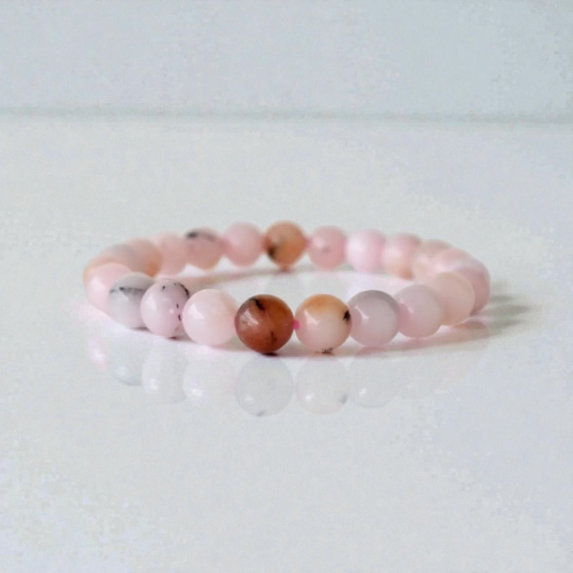 Pink Opal Bracelet featuring natural stone beads handcrafted into a soft pink crystal gemstone design, perfect for women who love healing and elegant jewelry. This delicate bracelet promotes emotional healing, love, and calm energy, making it an ideal gift for her or a thoughtful bridesmaid bracelet. Lightweight and feminine, it blends artisanal craftsmanship with the gentle beauty of pink opal, suitable for everyday wear or meaningful special occasions.