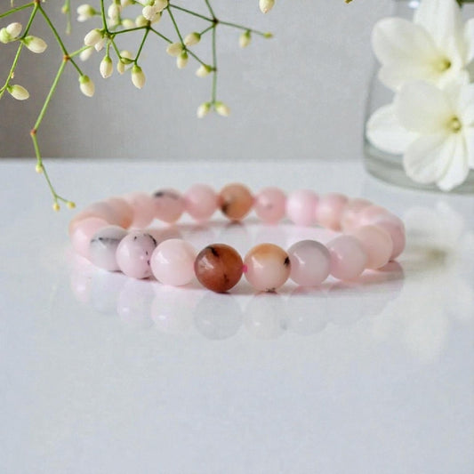 Pink Opal Bracelet featuring natural stone beads handcrafted into a soft pink crystal gemstone design, perfect for women who love healing and elegant jewelry. This delicate bracelet promotes emotional healing, love, and calm energy, making it an ideal gift for her or a thoughtful bridesmaid bracelet. Lightweight and feminine, it blends artisanal craftsmanship with the gentle beauty of pink opal, suitable for everyday wear or meaningful special occasions.