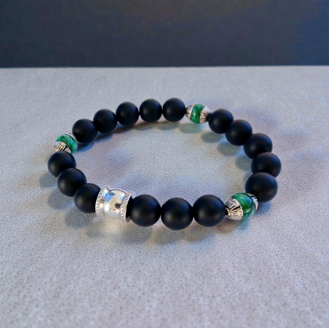 Natural Jade and Black Onyx Bracelet handcrafted as a men’s lucky charm and protection armband. This healing jewelry piece combines smooth jade and powerful black onyx stones, designed for strength, balance, and spiritual protection. Perfect handmade gift for him, ideal for birthdays, anniversaries, or wellness gifts. Stylish and meaningful, this men’s stretch bracelet blends natural energy with everyday wearable craftsmanship.